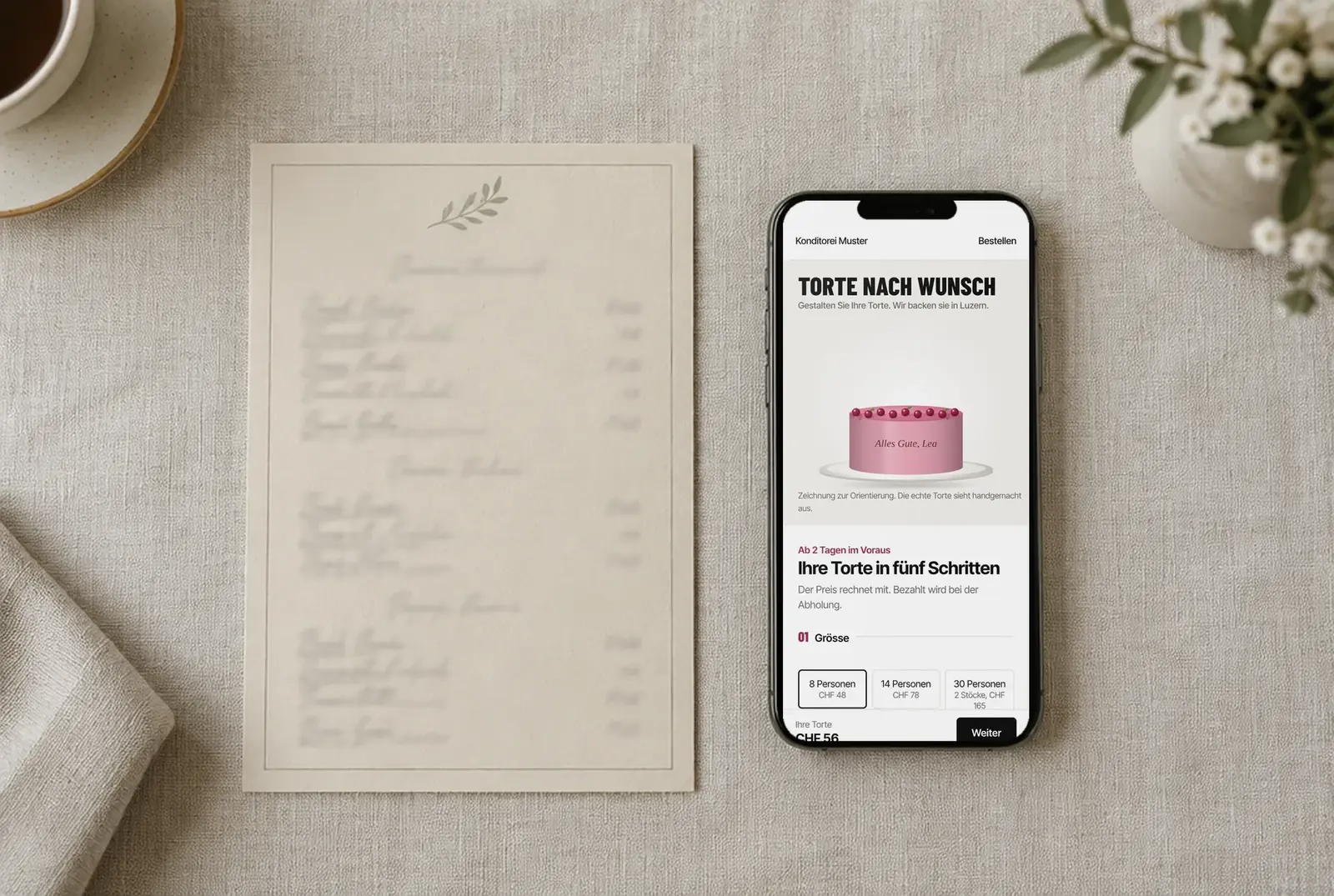 Printed menu next to a phone showing the demo website Konditorei Muster with its cake designer